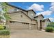 Two-story house with tan exterior, three-car garage, and landscaping at 1005 Sonesta Ave, Brandon, FL 33511