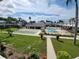 Community pool, shuffleboard courts, and lush landscaping at 4744 Azalea Dr # 203B, New Port Richey, FL 34652