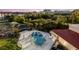 Community pool with patio furniture and surrounding trees at 204 3Rd W St # 406, Bradenton, FL 34205