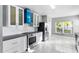 Modern kitchen with white cabinets, stainless steel appliances, and a blue backsplash at 2725 Terra Ceia Bay Blvd # 201, Palmetto, FL 34221