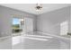 Large bedroom with tile floors and sliding doors to balcony at 2725 Terra Ceia Bay Blvd # 201, Palmetto, FL 34221