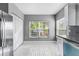 Modern kitchen with white cabinets, stainless steel appliances, and a window overlooking a patio at 2725 Terra Ceia Bay Blvd # 201, Palmetto, FL 34221