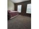 Bright bedroom featuring two windows, carpeted floor, and neutral walls for a calming atmosphere at 10453 Westpark Preserve Blvd, Tampa, FL 33625