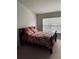 Bright bedroom with a double window dressed with a floral comforter at 10453 Westpark Preserve Blvd, Tampa, FL 33625