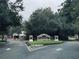 Westpark community entrance featuring sign, mature trees, and wrought iron gate at 10453 Westpark Preserve Blvd, Tampa, FL 33625