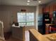 Cozy kitchen and entrance area with tile flooring, black appliances, and natural light from window at 10453 Westpark Preserve Blvd, Tampa, FL 33625