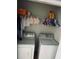 Laundry room has washer, dryer, storage shelf, and hanging rod at 10453 Westpark Preserve Blvd, Tampa, FL 33625