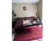 Comfortable living room features a sofa, ottoman and a red rug at 10453 Westpark Preserve Blvd, Tampa, FL 33625