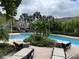 Relaxing community pool with lounge chairs and tropical landscaping at 10453 Westpark Preserve Blvd, Tampa, FL 33625
