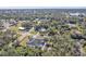 An aerial view showcasing a single-Gathering home with a pool and surrounding landscape at 18482 Holly Ave, Port Charlotte, FL 33948