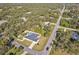 Aerial view of a house with a pool, located on a tree-lined street at 18482 Holly Ave, Port Charlotte, FL 33948