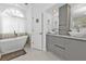 Elegant bathroom with a double vanity, modern finishes, and a soaking tub at 18482 Holly Ave, Port Charlotte, FL 33948