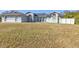 House exterior featuring light blue paint, a large lawn, and a white fence at 18482 Holly Ave, Port Charlotte, FL 33948