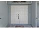Double white front doors with a decorative doormat at 18482 Holly Ave, Port Charlotte, FL 33948