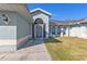 Front entrance with a screened-in porch and a walkway at 18482 Holly Ave, Port Charlotte, FL 33948