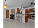 Kitchen with breakfast bar, stainless steel appliances, and wood cabinets at 18482 Holly Ave, Port Charlotte, FL 33948