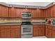 Kitchen with stainless steel appliances and wood cabinets at 18482 Holly Ave, Port Charlotte, FL 33948