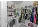 Clean laundry room with washer, dryer, shelving, and ample closet space at 18482 Holly Ave, Port Charlotte, FL 33948