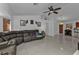 Living room boasts a sectional sofa and ceiling fan at 18482 Holly Ave, Port Charlotte, FL 33948