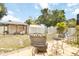 Backyard area including an outdoor dining set, fire pit, gazebo and privacy fence at 1801 40Th N St, St Petersburg, FL 33713