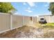 Enclosed backyard with a trailer parked behind the vinyl fence, offering a private outdoor space at 1801 40Th N St, St Petersburg, FL 33713