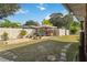 Expansive backyard featuring a covered gazebo with comfortable seating and a mix of grass and stone pathways at 1801 40Th N St, St Petersburg, FL 33713
