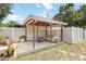 Covered outdoor living space with comfortable seating, offering a relaxing retreat overlooking the spacious backyard at 1801 40Th N St, St Petersburg, FL 33713