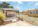 Covered outdoor living space with comfortable seating, offering a relaxing retreat overlooking the spacious backyard at 1801 40Th N St, St Petersburg, FL 33713