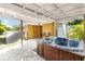 Backyard with a covered patio featuring a hot tub, hammock, and stone-paved flooring at 1801 40Th N St, St Petersburg, FL 33713