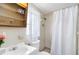 Modest bathroom featuring a shower, toilet, sink, and cabinet storage space at 1801 40Th N St, St Petersburg, FL 33713