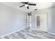 A bright bedroom with a ceiling fan and a double closet with mirrored doors at 1801 40Th N St, St Petersburg, FL 33713