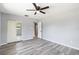 Bedroom featuring closet with mirrored doors, wood look floors and bright natural light at 1801 40Th N St, St Petersburg, FL 33713