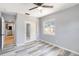 Bright bedroom with wood-look flooring, ceiling fan and closet with mirrored doors at 1801 40Th N St, St Petersburg, FL 33713