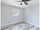 A bright bedroom with wood-look flooring, a ceiling fan and a view outside the window at 1801 40Th N St, St Petersburg, FL 33713