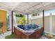 Relaxing hot tub under a covered patio, surrounded by stone flooring at 1801 40Th N St, St Petersburg, FL 33713
