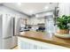 An open kitchen featuring stainless steel appliances, white cabinets, and a wooden counter at 1801 40Th N St, St Petersburg, FL 33713