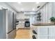 An open kitchen featuring stainless steel appliances, white cabinets, and a wooden counter at 1801 40Th N St, St Petersburg, FL 33713