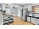 Open kitchen with stainless steel appliances, light cabinets, and hardwood floors at 1801 40Th N St, St Petersburg, FL 33713