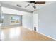 Living room with hardwood floors, light gray walls, a ceiling fan, and large windows at 1801 40Th N St, St Petersburg, FL 33713