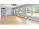 Living room with hardwood floors, light gray walls, and large windows at 1801 40Th N St, St Petersburg, FL 33713