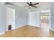 Bright living room featuring wood floors, ceiling fan, and an open layout to an adjacent room at 1801 40Th N St, St Petersburg, FL 33713