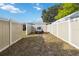 Fenced backyard with a trailer and grassy area at 1801 40Th N St, St Petersburg, FL 33713