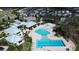 Aerial view of the community pool and clubhouse, featuring a pool with lap lanes, splash pad, and lounging areas at 12764 Weston Oaks Ln, Riverview, FL 33579