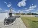 Backyard with manicured lawn and patio area provides ample space for outdoor activities and relaxation at 12764 Weston Oaks Ln, Riverview, FL 33579