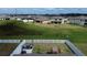 Aerial view of a spacious backyard with a white fence, patio furniture, and a playground, perfect for outdoor enjoyment at 12764 Weston Oaks Ln, Riverview, FL 33579
