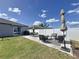 Backyard patio with outdoor furniture and well-manicured lawn, ideal for entertaining at 12764 Weston Oaks Ln, Riverview, FL 33579