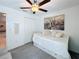 This bedroom features a ceiling fan, a closet, art, and a twin bed at 12764 Weston Oaks Ln, Riverview, FL 33579