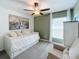 This bedroom features a ceiling fan, green accent wall, a window, and a twin bed at 12764 Weston Oaks Ln, Riverview, FL 33579