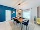 Dining area featuring a wood table, velvet chairs, a modern light fixture, and a view of the living room at 12764 Weston Oaks Ln, Riverview, FL 33579