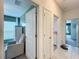 Hallway view showcases bright doorway leading into a bedroom and another doorway to an office at 12764 Weston Oaks Ln, Riverview, FL 33579